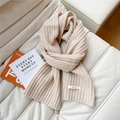 Detailed macro view of 100% wool cream white scarf showing premium ribbed knit texture - Beige