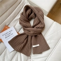 Detail of chunky coffee brown knitted wool scarf with 100% WOOL material label - Brown