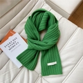 Detail of grass green wool scarf featuring rib knit texture and 100% wool material tag - Dark Green