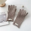 Close-up of 100% wool knitted gloves in khaki featuring a minimal woven logo label - Brown
