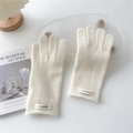 Detailed view of cream 100% wool knitted gloves showing soft texture and quality material - Cream