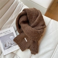 Detail of soft brown knitted scarf with metal logo plate on white textured fabric - Brown
