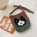 Detail of knit bag featuring a cat pattern weave on a textured warm background - Green Orange Mixed