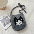 Macro detail of grey knitted shoulder bag with cute black and white cat pattern texture - Gray