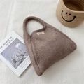 Close-up of brown knitted tote bag featuring a textured weave and minimalist label - Brown
