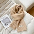 Close-up of beige chunky knit scarf with brand label on a soft leather sofa - 20*160cm / Camel