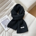 Close-up of black knitted scarf with rib texture and elegant brand label on white leather - 20*160cm / Black