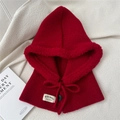 Close-up of a dark red knit balaclava with faux fur trim and branded label detail - One Size / Red