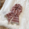 Close-up of pink striped knitted scarf featuring soft fringe and woven wool brand label - Pink Color Fringe Stripes