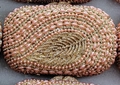 Close-up of pink marquise pearls and sparkling crystals on a luxury evening clutch bag - Champagne Gold