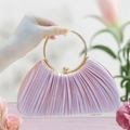 Detail of light pink satin pleated evening bag with elegant golden round metal handle - Pink