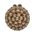 Close-up of champagne crystals and gold metal clasp on a round evening handbag - Gold