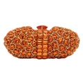 Macro detail of luxury evening clutch featuring orange crystals and fan-shaped metal clasp - Orange