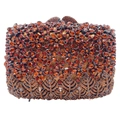 Close-up of amber rhinestones forming flower patterns on a luxury evening clutch bag - Brown