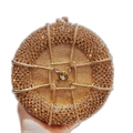 Close-up of champagne gold round clutch featuring intricate rhinestones and a large center gem - Champagne