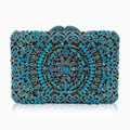 Detail of blue rhinestone evening clutch showing intricate hollow metal mandala pattern - Peacock Blue