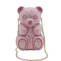 Detailed macro view of pink crystal rhinestones on the bear-shaped party handbag - Pink