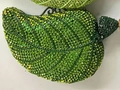Macro detail of leaf-shaped evening clutch with green gradient crystal rhinestones - Green