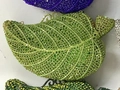 Macro view of crystal encrusted leaf-shaped clutch bag showing intricate green rhinestones - Light Green