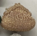 Detail of a luxury gold rhinestone evening clutch bag with sparkling diamond-set surface - Champagne