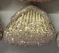 Detail of shimmering silver and yellow rhinestones on an elegant shell dinner clutch bag - Gold AB