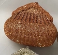 Close-up of pleated rhinestone evening clutch bag in orange bronze sparkling finish - Orange