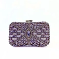 Detailed macro view of purple marquise-cut crystals on gold metal evening clutch bag - Violet