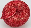 Macro shot of red apple-shaped evening clutch bag with sparkling rhinestone encrusting - Red