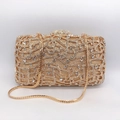 Detailed view of hollow musical note pattern and crystals on golden evening clutch - Music / Gold