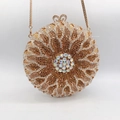Detail of flower-shaped crystal clutch bag with golden petals and sparkling aurora center - Gold Brown