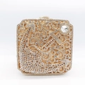 Detailed shot of golden evening clutch bag featuring intricate crystal vine scrollwork - Gold / White Zirconia