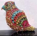 Macro shot of colorful crystal parrot clutch with vibrant gems and gold metal frame - Gold Multicolor with Blue Beak