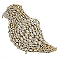 Macro detail of bird-shaped clutch bag encrusted with sparkling crystals and gold frame - Gold White