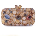 Close-up of luxury evening clutch with inlaid agate stones and gold metal frame - Apricot Coffee