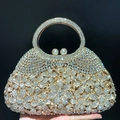 Detail of luxury rhinestone evening clutch bag with crystal daisy pattern and pearl clasp - Gold