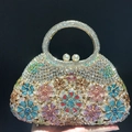 Macro view of crystal flower evening bag with rhinestone petals and pearl clasp - Pink Multi