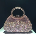 Detailed close-up of crystal evening bag with purple rhinestone flowers and gold handle - Light Purple