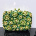 Green crystal floral clutch bag with hollow pattern and gold clasp on reflective surface - Green Gradient