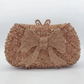 Rose gold luxury clutch bag with rhinestone bow design and glittering diamond finish - Gold