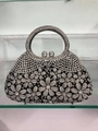 Elegant black dinner clutch bag with silver rhinestone flower pattern and round metal handle - Black