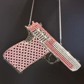 Macro view of crystal-encrusted gun-shaped clutch featuring pink and silver rhinestones - Black Pink