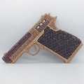 Macro shot of handgun evening bag showing detailed gold and black rhinestone embellishments - Black Gold Purple