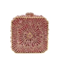 Close-up of pink rhinestones in radial pattern on a gold-framed luxury clutch bag - Pink