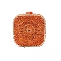 Macro shot of orange evening clutch featuring radial rhinestone inlay and metallic frame - Orange