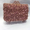 Detalle de bolso de fiesta de cristal rosa con cierre metálico dorado ondulado y brillo - Rosa