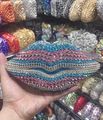 Detail of a lip-shaped clutch bag fully encrusted with colorful sparkling rhinestones - Blue Gradient