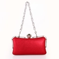 Detail of red metallic evening clutch with floral diamond clasp and silver chain - Red