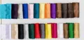 Selection of 26 colors for pleated silk evening bags displayed on a fabric swatch grid - Custom Colors (MOQ 50)
