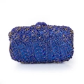Macro detail of royal blue crystals and gold hollow flower frame on evening clutch bag - Sapphire Blue