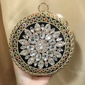 Close-up of circular evening bag with colorful rhinestones and floral gem pattern - Black